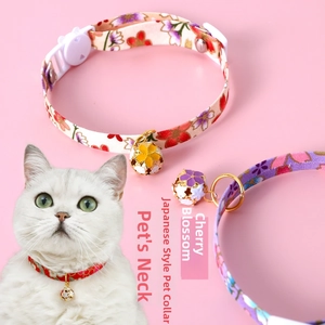 Detail of adjustable pet collar with Japanese cherry blossom print and metal bell