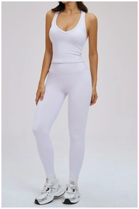 Detail of white two-piece yoga set with deep V-neck tank top and high waist leggings
