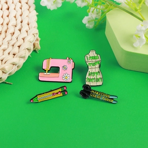 Detail view of four sewing-themed enamel pins including a pink floral machine and tailor shears