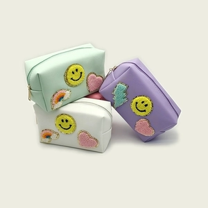 Three-piece set of portable PU makeup bags with chenille patches and smiley embroidery