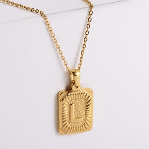 18K gold plated stainless steel necklace with a rectangular letter L pendant on white stone