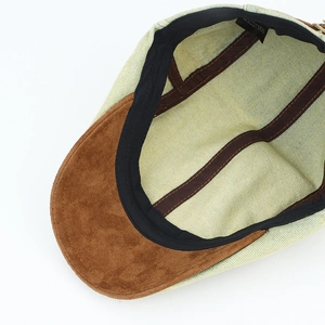 Detailed interior of vintage denim newsboy cap featuring 100% cotton label and suede brim
