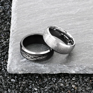 Men's Viking Celtic knot rings in silver and black finish on stone background