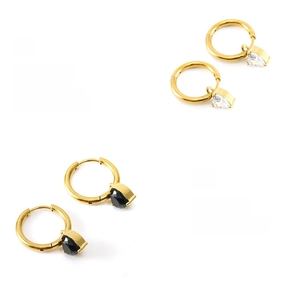 Polished gold earrings with heart-shaped clear and black zirconia pendants macro view