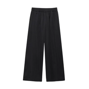Detail of black wide-leg trousers with elastic waist and soft textured fabric