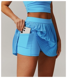 Detail of sky blue pleated tennis skirt featuring a practical side pocket on the inner shorts