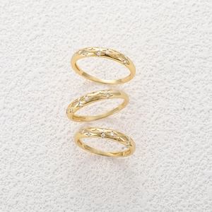Close-up of S925 sterling silver hallmark and cubic zirconia on gold star rings