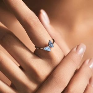 Elegant s925 silver butterfly ring with light blue crystal on model finger