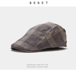 Detail of retro grey and brown plaid beret hat with soft corduroy fabric texture