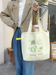 Beige canvas tote bag with apple embroidery and drawstring closure for women