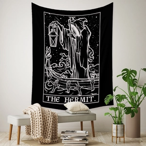Detail view of monochrome The Hermit tarot tapestry hanging in a minimalist Nordic room