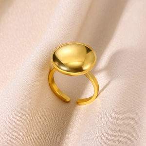 Detailed view of a gold-plated stainless steel ring with a round polished convex surface