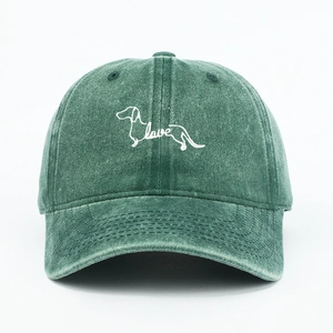 Detail of dachshund dog and love letter embroidery on dark green washed cotton cap