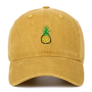 Close-up of yellow washed cotton baseball cap featuring small pineapple embroidery detail