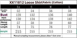 Detail of loose-fit poplin shirt featuring a curved hem and turn-down collar design