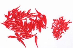 Close-up of bright red chili-shaped plastic pendants with glossy finish and top hanging holes