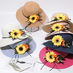 Detailed close-up of colorful woven sun hats with exquisite floral sunflower decorations