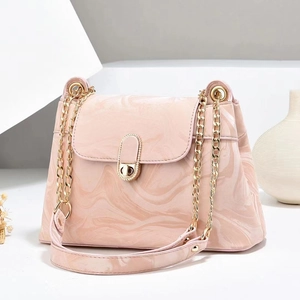 Pink marble print crossbody bag with gold chain strap and polished flap closure