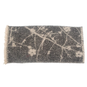 Detail of grey floral jacquard scarf with soft texture and short fringe tassels