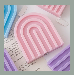 Rainbow arch scented candles in pastel pink, purple and blue tones on vintage paper