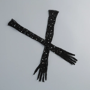 Close-up of black mesh gloves with sparkling rhinestones and elastic sheer fabric