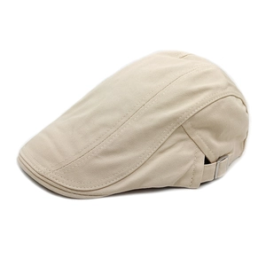 Detail of beige cotton flat cap showing adjustable silver metal buckle and fabric texture