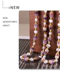 Detail of beaded necklace with purple amethyst and pearls on a vintage wooden prop
