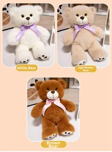 Detail of plush teddy bears in white and brown with polka dot ribbon bows and paw pads