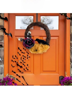 Halloween wreath with black crows and purple roses displayed on an orange door