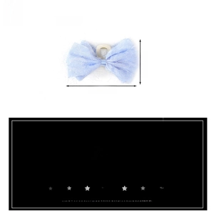 Detail showing soft blue fabric texture and large bow structure of the hair claw clip