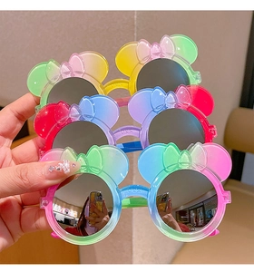 Detail of girl's sunglasses with Minnie mouse ears and vibrant gradient macaron frames