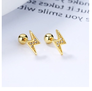 Macro shot of 925 silver lightning bolt studs with gold plating and zircon inlay
