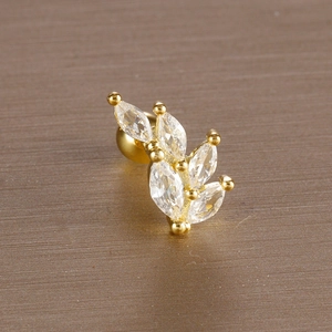 Detailed macro view of gold-colored leaf stud earring with 5 marquise-cut crystals