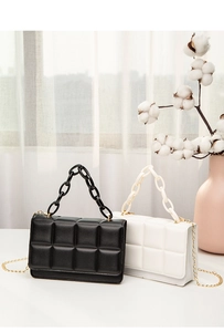 Quilted crossbody bags in black and white with chunky resin chains and metal straps