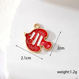 Macro shot showing dimensions 2.1cm x 2cm and 1.2g weight for red enamel fish pendant