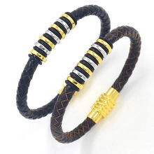 Close-up of black and brown braided leather bracelets with metallic magnetic clasps