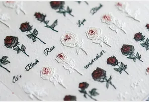 Détail macro de stickers ongles 5D en relief avec roses rouges, noires et blanches