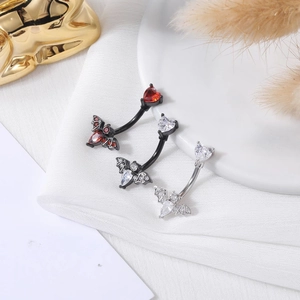 Three stainless steel bat belly rings with heart crystals in black and silver finishes
