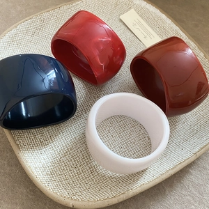 Irregular resin bangles in deep blue and marble patterns on a ceramic plate