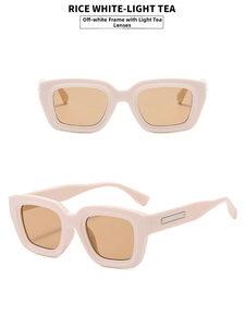 Detail view of cream rectangle sunglasses with light tea lenses and silver metal hinges