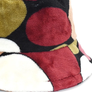 Detail of plush coral fleece bucket hat featuring colorful polka dot pattern for winter