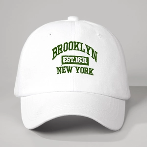Detail of Brooklyn New York green embroidery on white cotton baseball cap