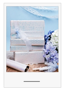 Macro shot of stacked light blue gift boxes featuring elegant patterns and ribbon