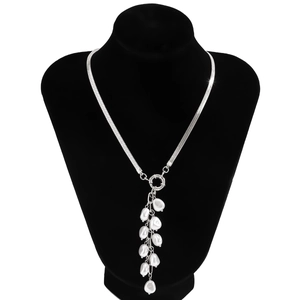Detail of silver snake chain necklace with baroque faux pearls on a black mannequin