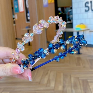 Sparkling crystal headbands in pink and blue colors shown in a close-up lifestyle view