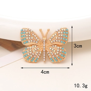 Detail of blue rhinestone butterfly accessory with dimensions 4cm x 3cm and weight 10.3g