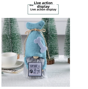 Detail of blue knitted gnome holding a wooden sign with dog-themed home quote