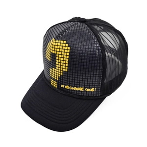 Detail view of black mesh trucker hat featuring yellow pixel question mark and text print