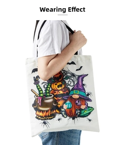 Detailed view of Halloween canvas tote bag with gnome pumpkin print worn by a model
