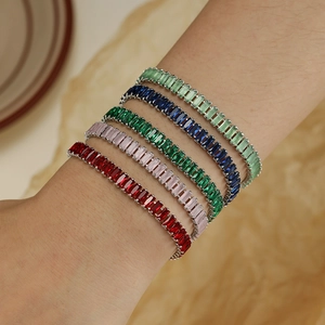 Minimalist rectangular crystal bracelets set in five vibrant colors worn by model